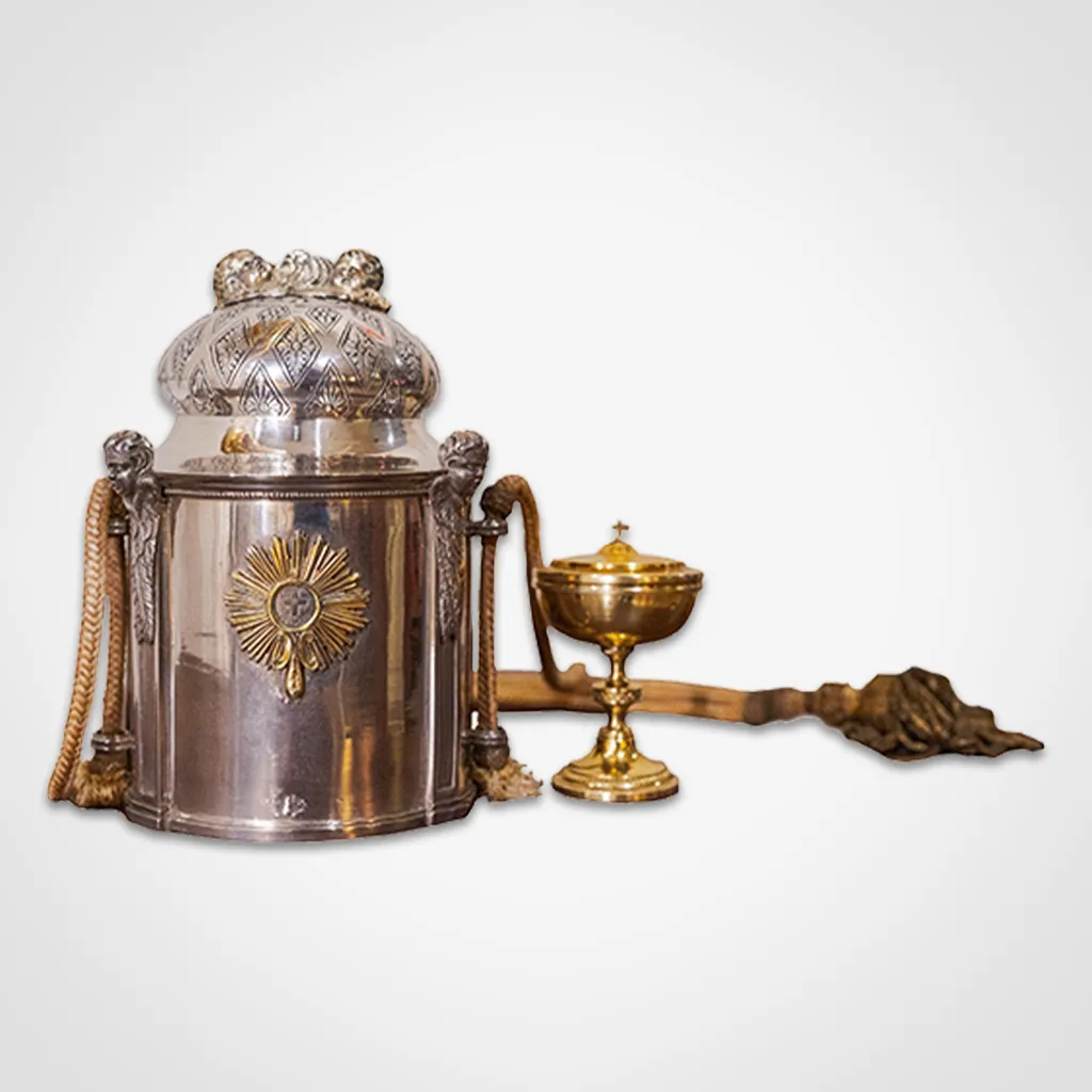 silver reliquary with ornate details and a golden chalice on a white background