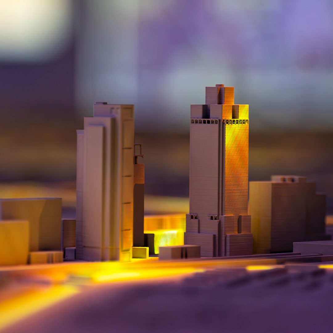 3D model of Amsterdam city skyline with illuminated buildings and glowing yellow pathways at dusk