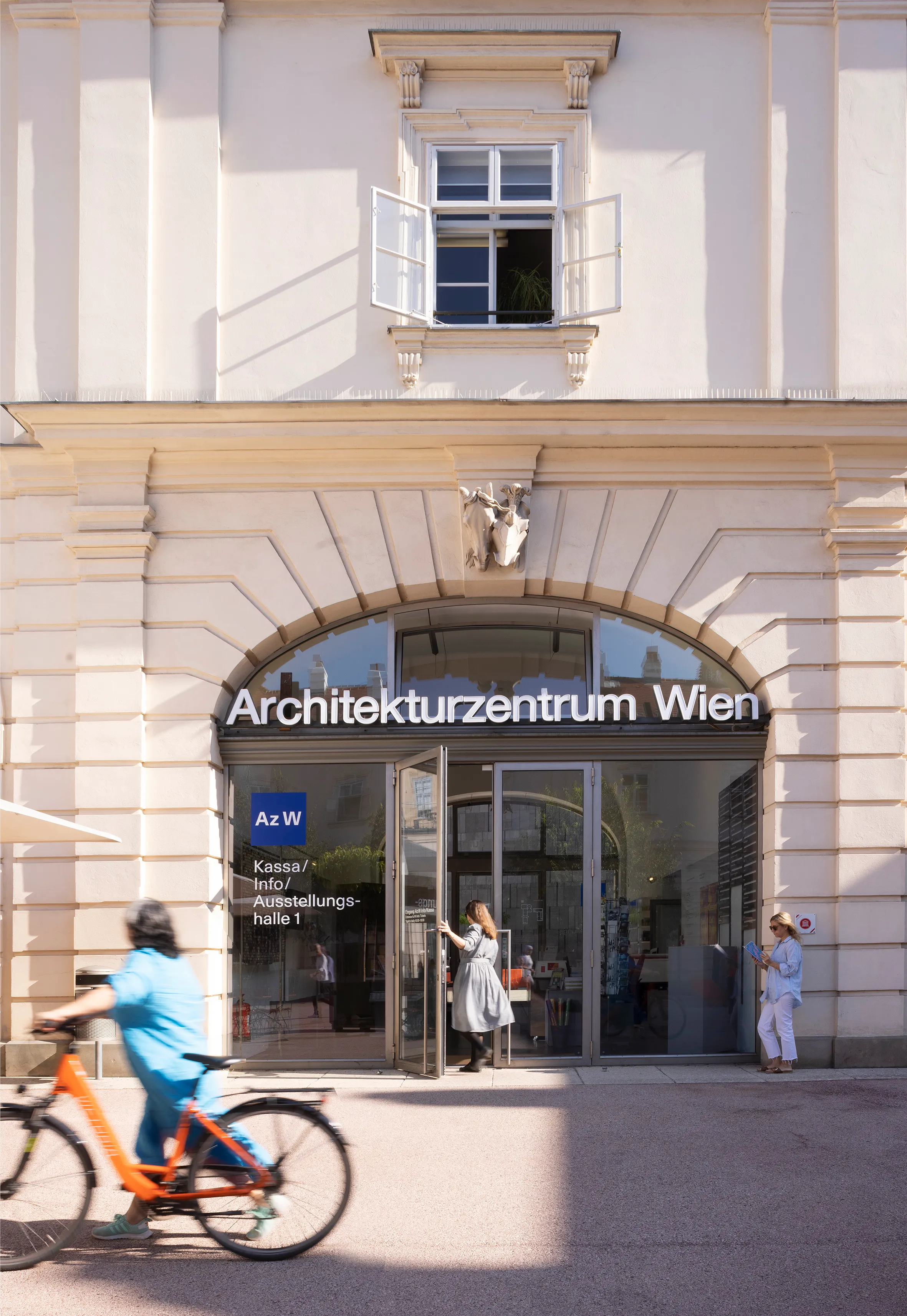 The entrance to the Architekturzentrum Wien with a person on a bicycle in the foreground