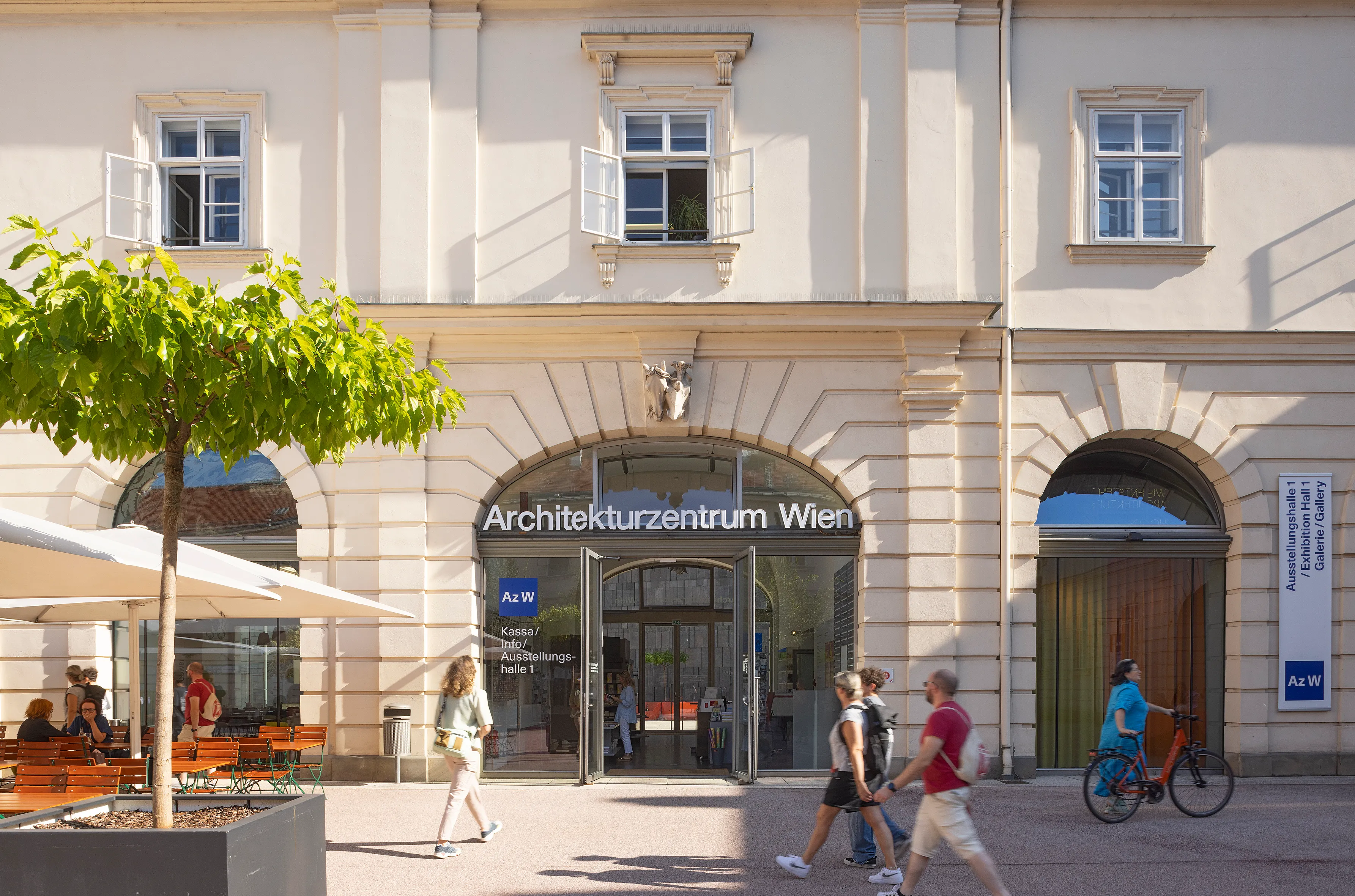 Entrance to Architekturzentrum Wien with people walking past on a sunny day