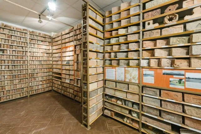 Interior of the Brick Museum with shelves filled with brick samples and ceramic artifacts