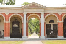 Classical gateway with red brick arches and white columns at Central Cemetery