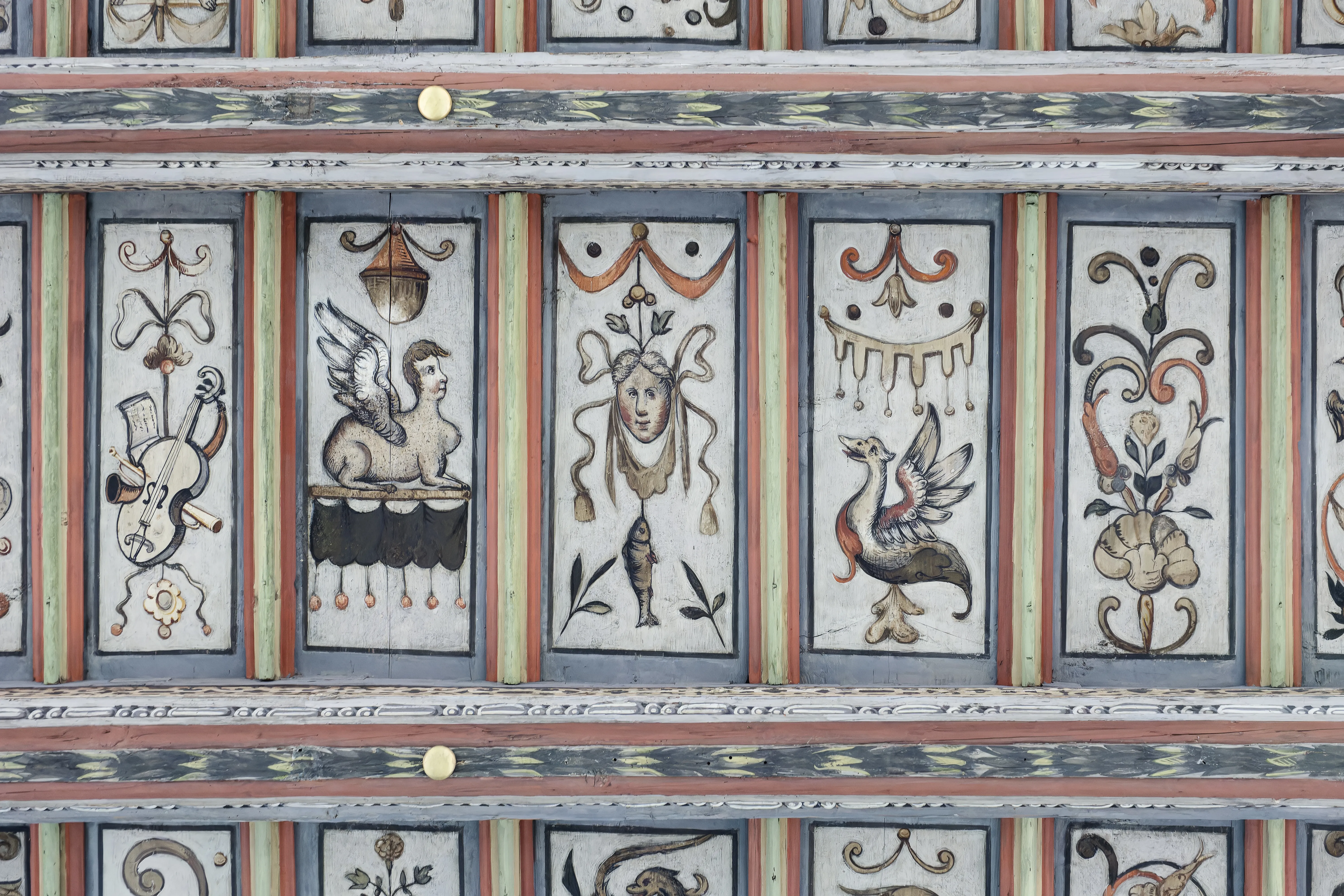 ornate painted panels with decorative motifs on a ceiling