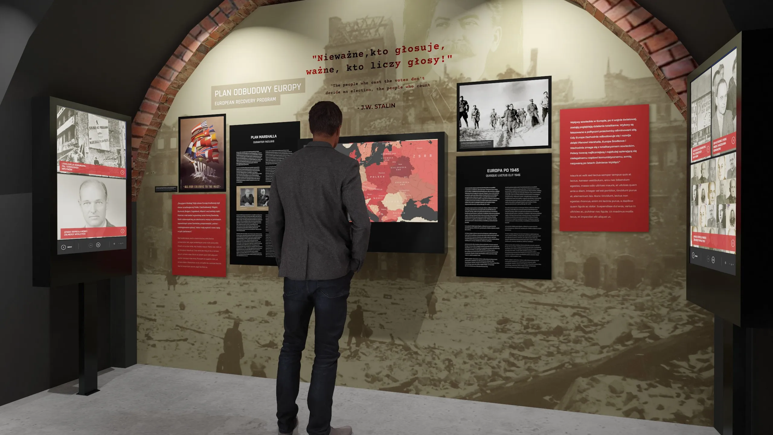 persona de pie frente a una exhibición con pantallas y paneles informativos en un museo