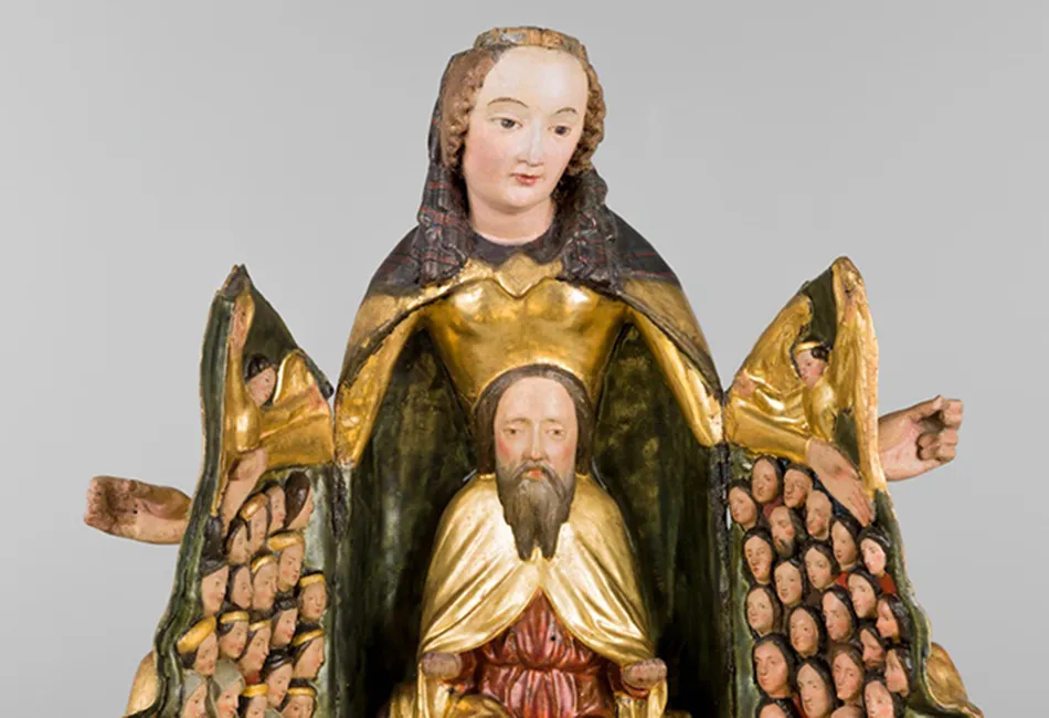 religieuze sculptuur van een bebaard figuur in gouden gewaden met een grotere figuur erachter