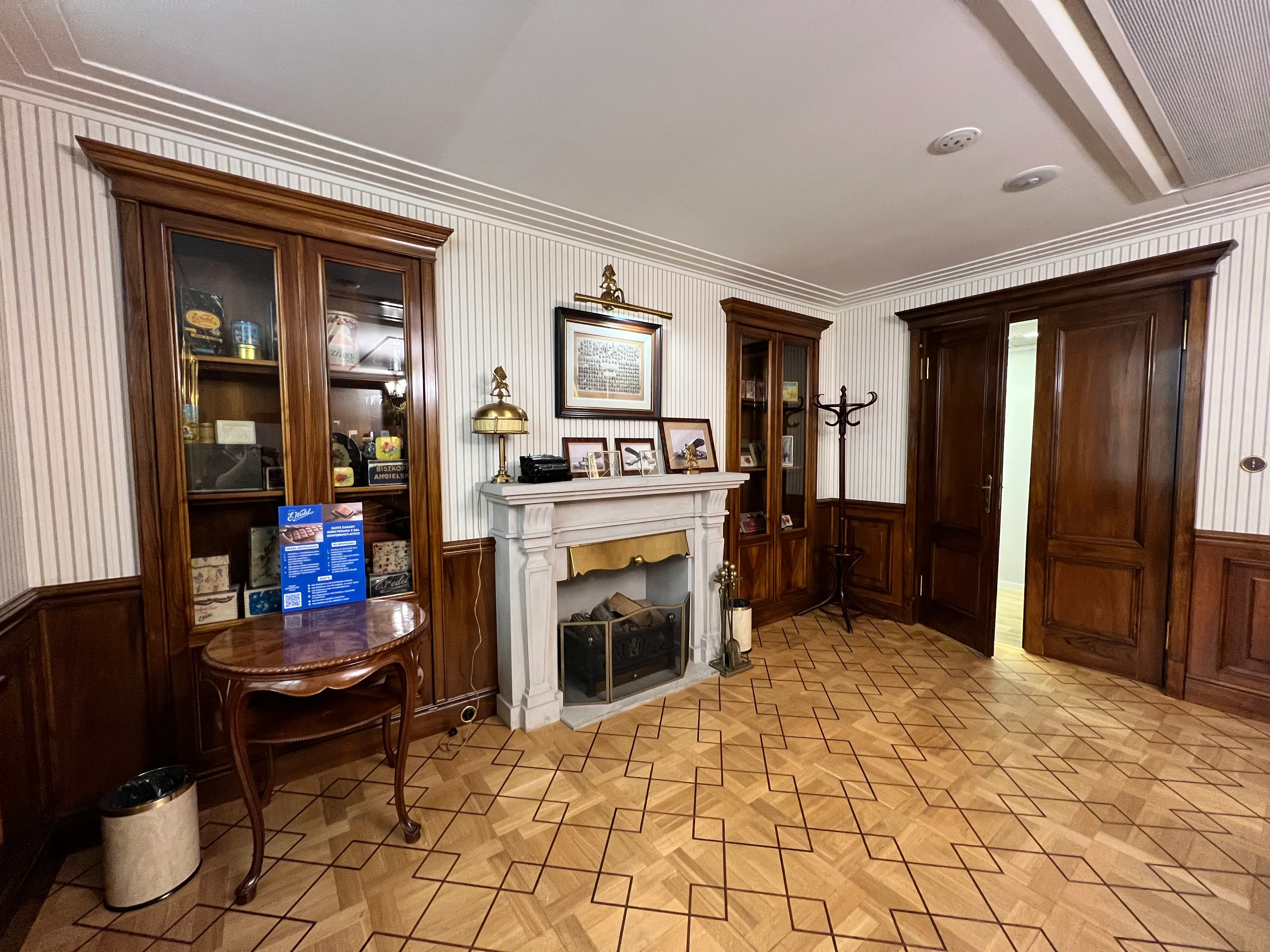 Interior room with wooden cabinets, a fireplace, and parquet flooring