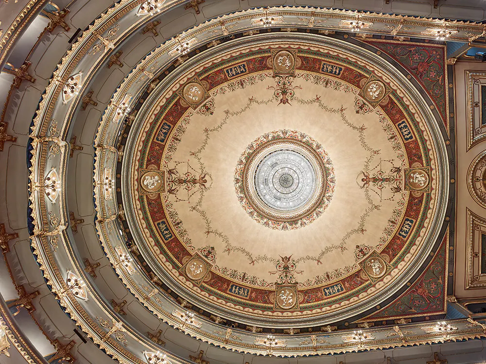 Ornate circular ceiling with gold detailing and decorative motifs in the Estates Theatre