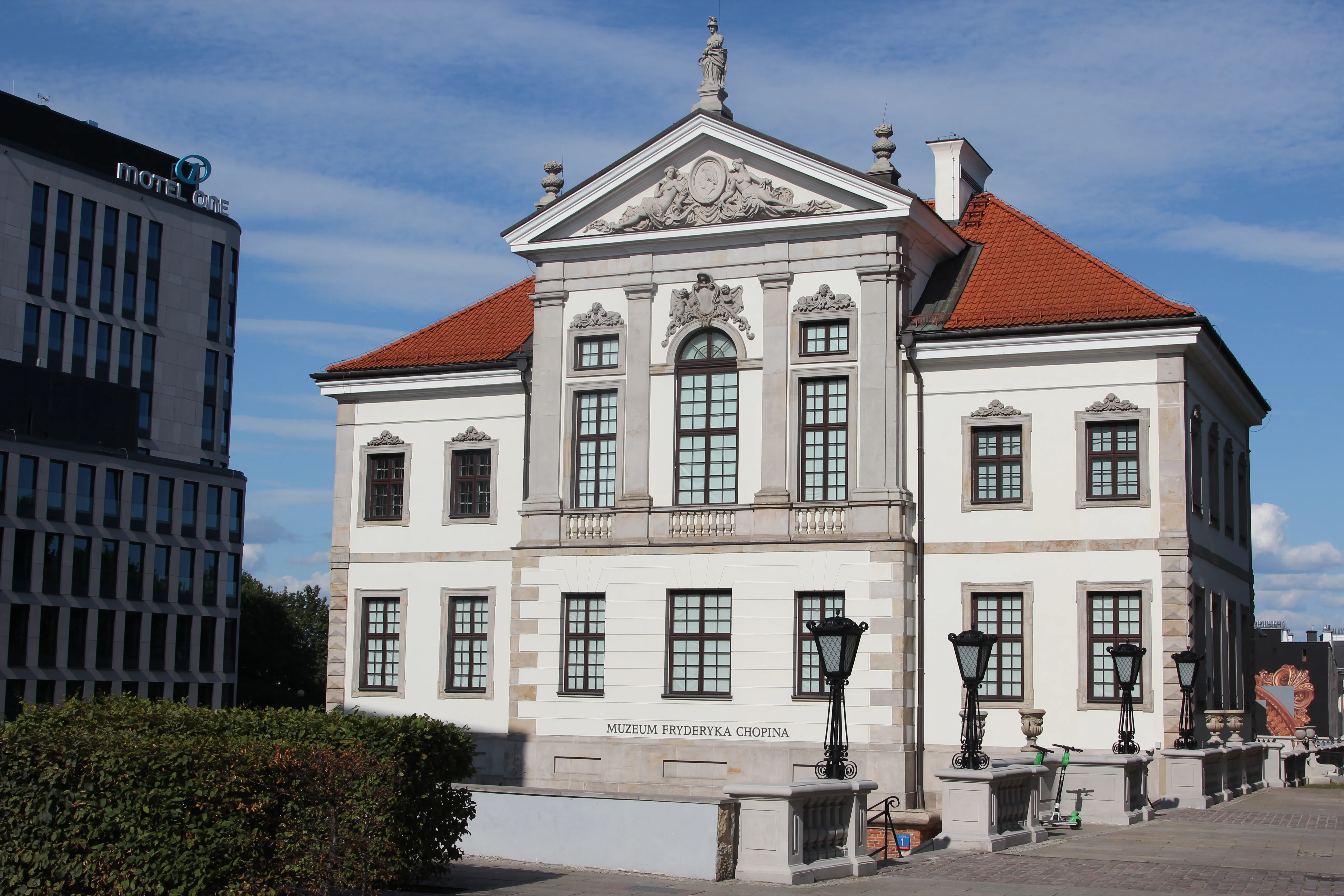 Classical white building with red roof and ornate details, identified as the Fryderyk Chopin Museum in Warsaw