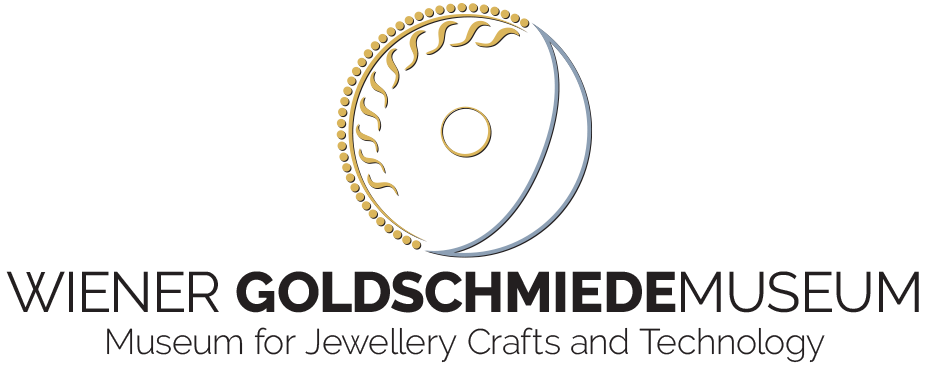 Un logo circular dorado con un diseño de media luna sobre un fondo negro, con el texto 'WIENER GOLDSCHMIEDEMUSEUM' y 'Museo de Artesanía y Tecnología de la Joyería'.