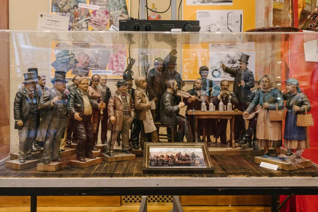 vitrine met historische beeldjes in kledij uit die tijd, opgesteld rond een tafereel