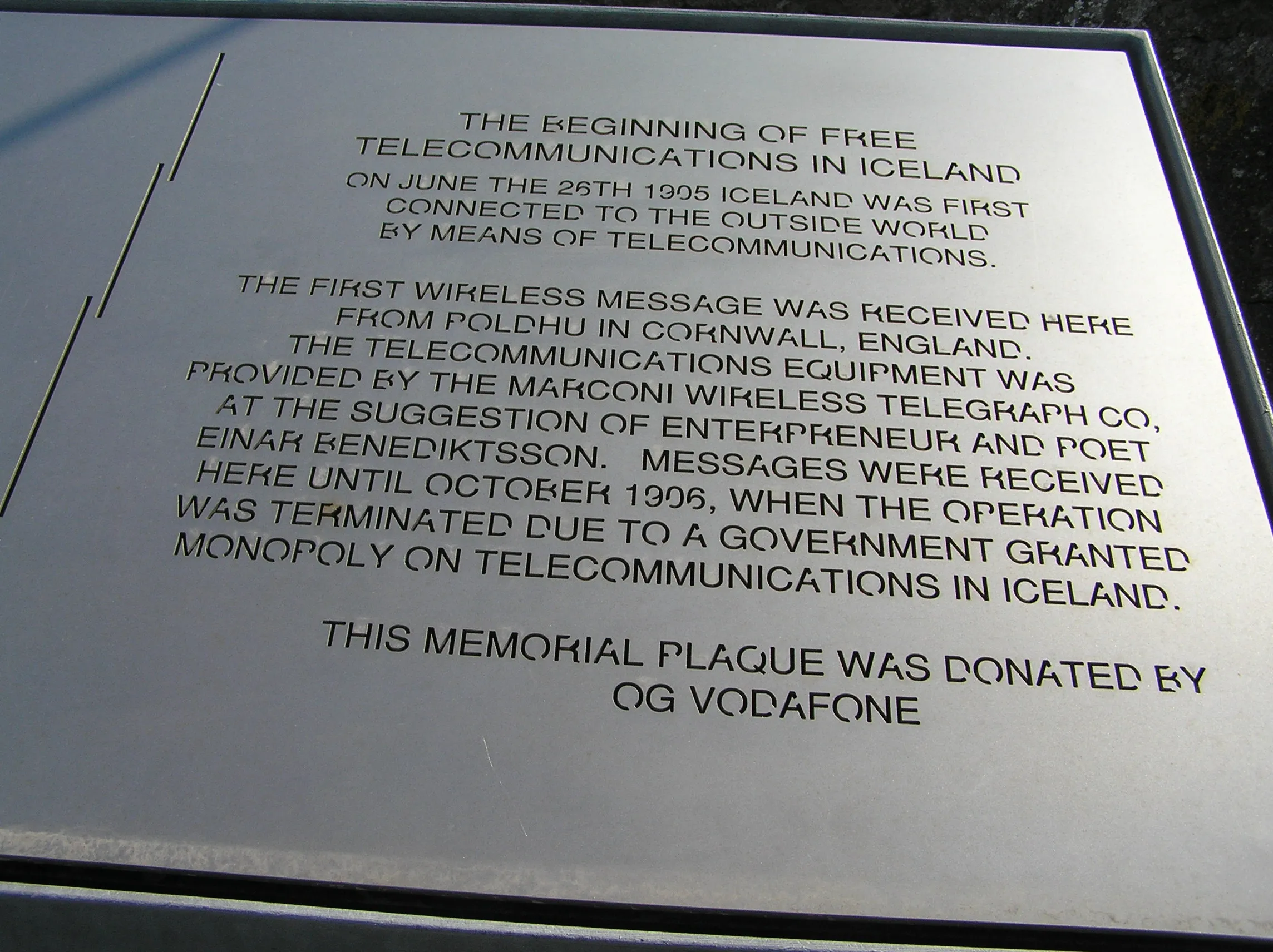 A silver memorial plaque at Höfði House commemorating the beginning of free telecommunications in Iceland on June 26th, 1905, donated by Vodafone