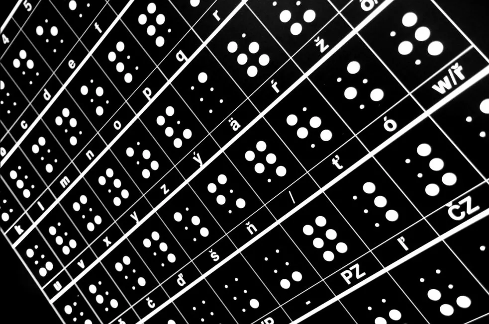 close-up van braillekaart met Tsjechische letters op zwarte achtergrond