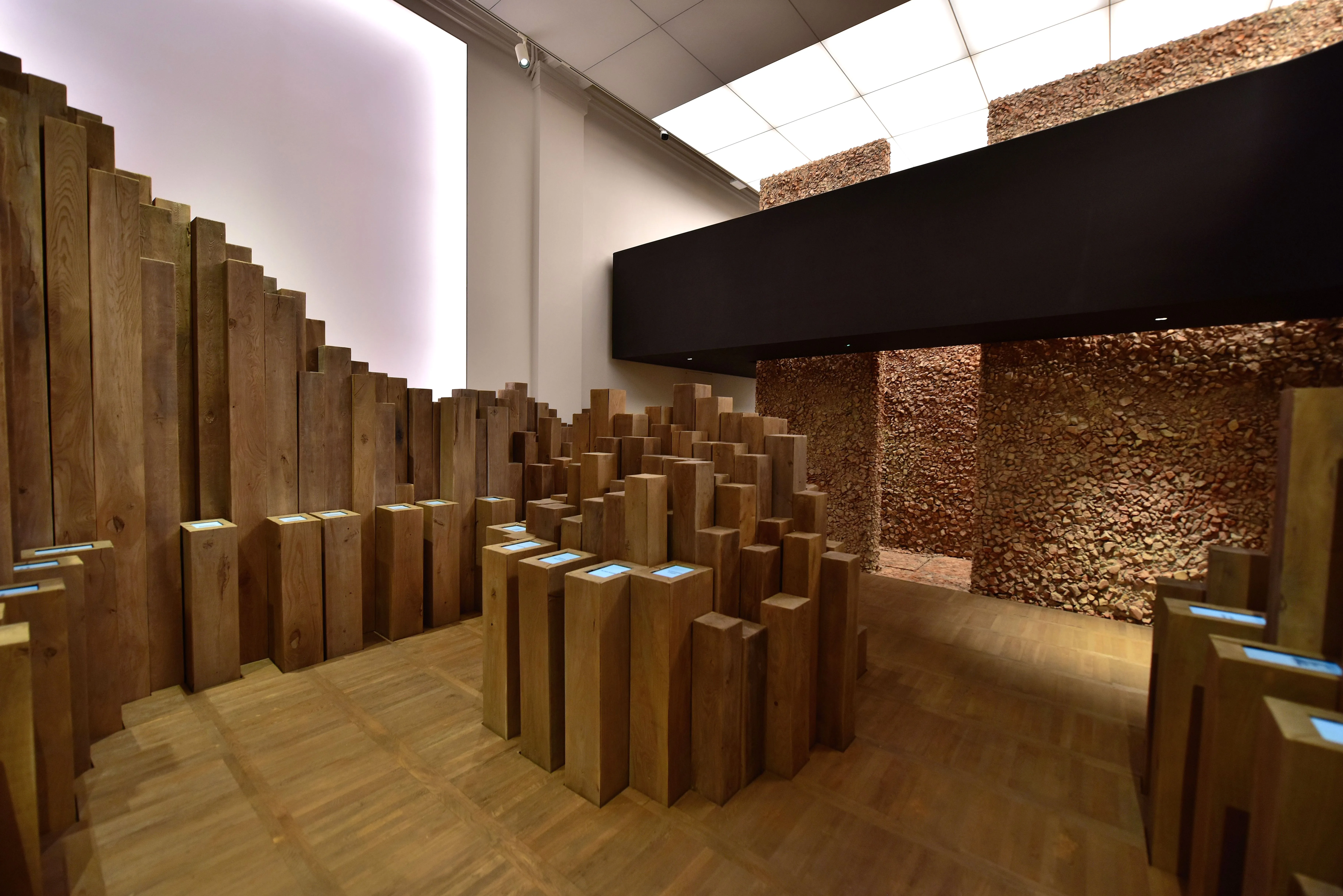 wooden blocks arranged in a stepped formation in an exhibition space