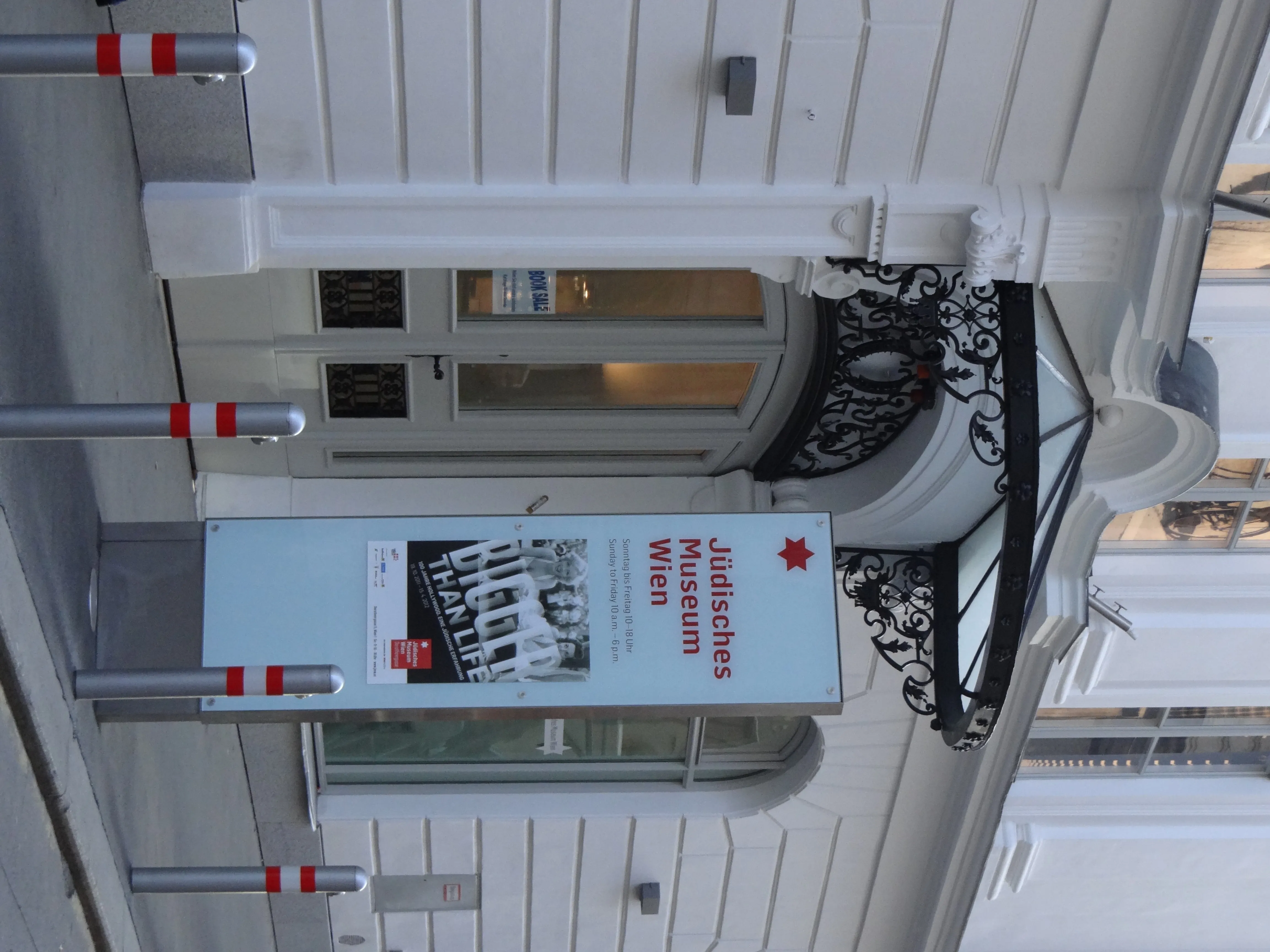white building facade with arched entrance and a banner for Jewish Museum Vienna