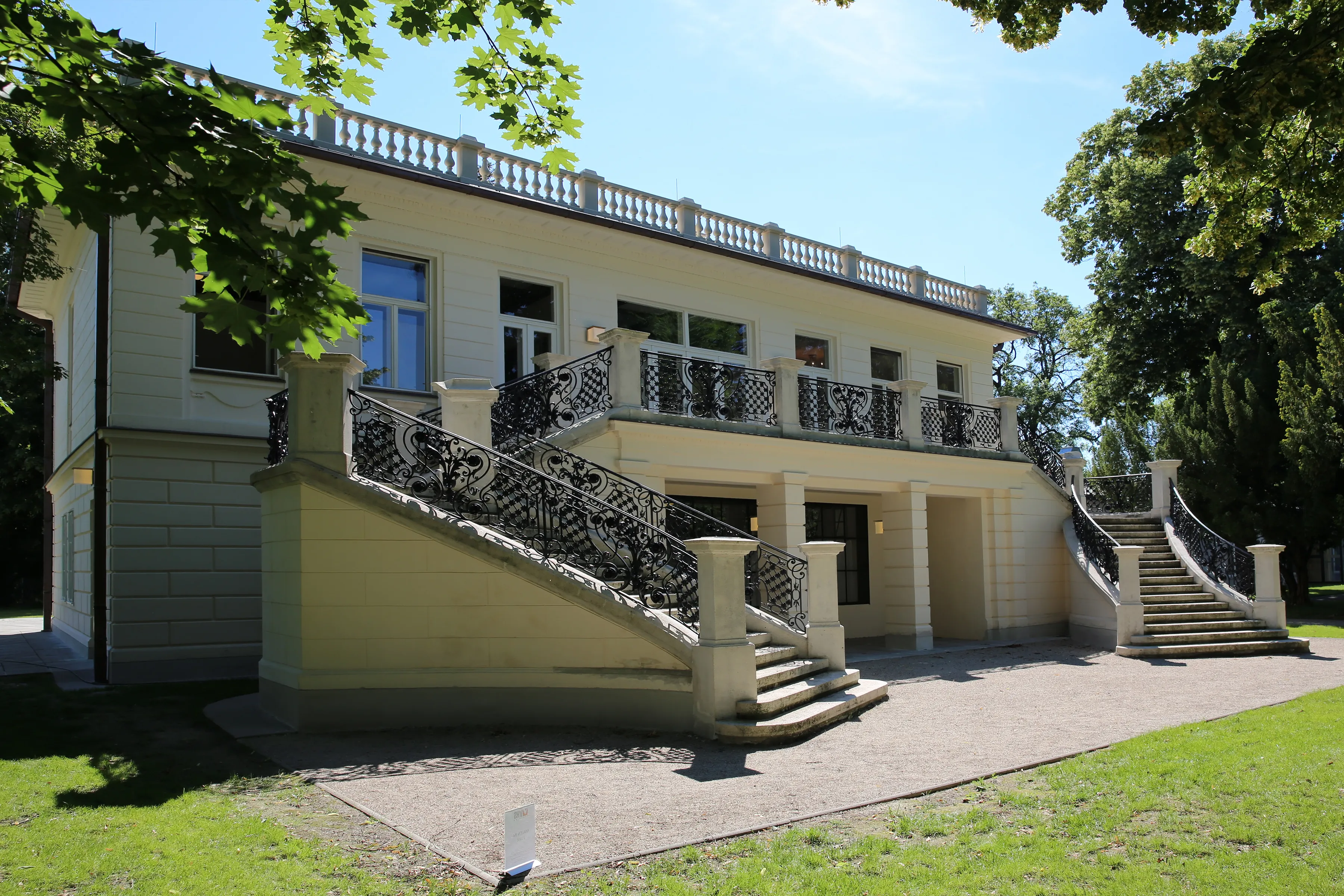 Exterior of the Klimt Villa with a large staircase and ornate railings