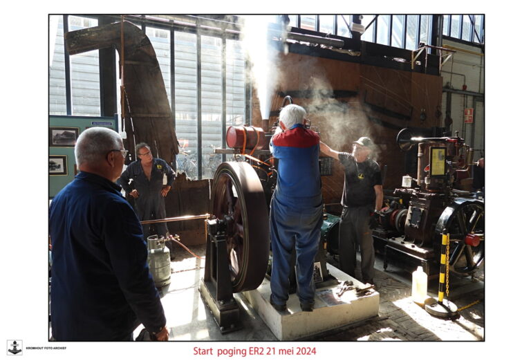 Three people working around large steam-emitting industrial machinery in a workshop; text at bottom reads 'Start poging ER2 21 mei 2024'