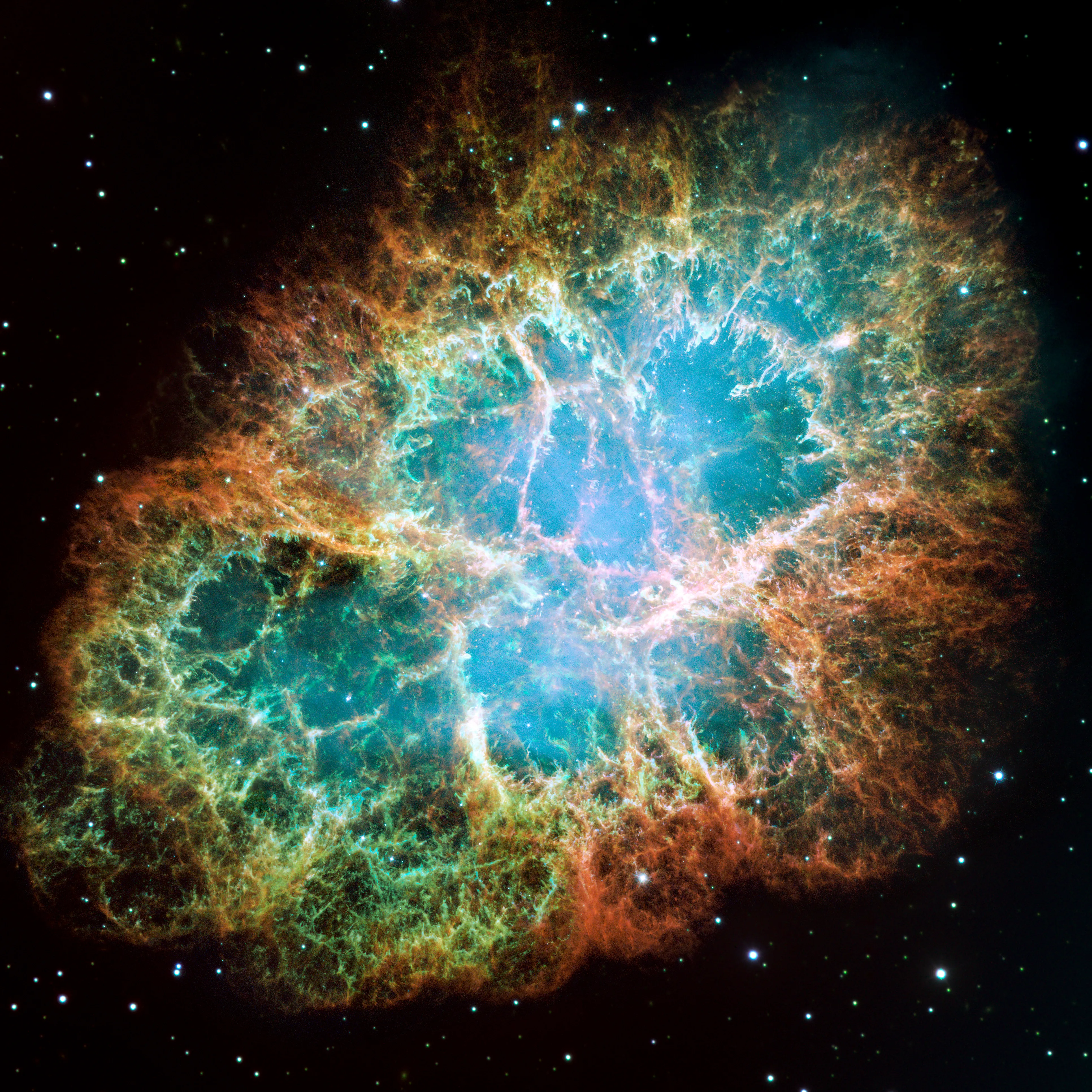 Una nebulosa colorida con filamentos azules, verdes y naranjas sobre un fondo estrellado oscuro