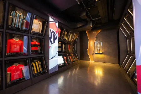 football jerseys displayed in glass cases in a dimly lit gallery