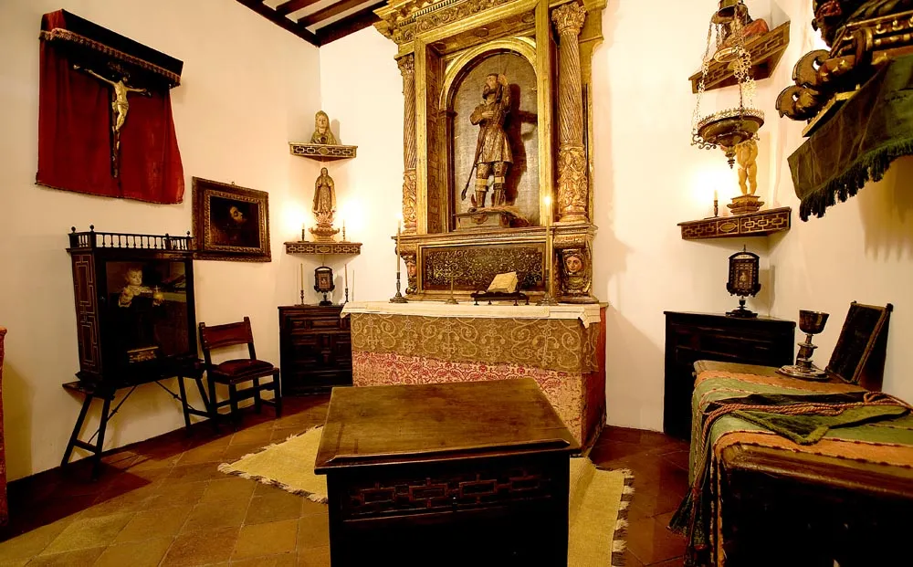 Interior room of the House-Museum of Lope de Vega with a central altar, wooden furniture, and religious artwork