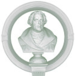 Circular emblem featuring a white bust of a historical figure on a pedestal within a ring