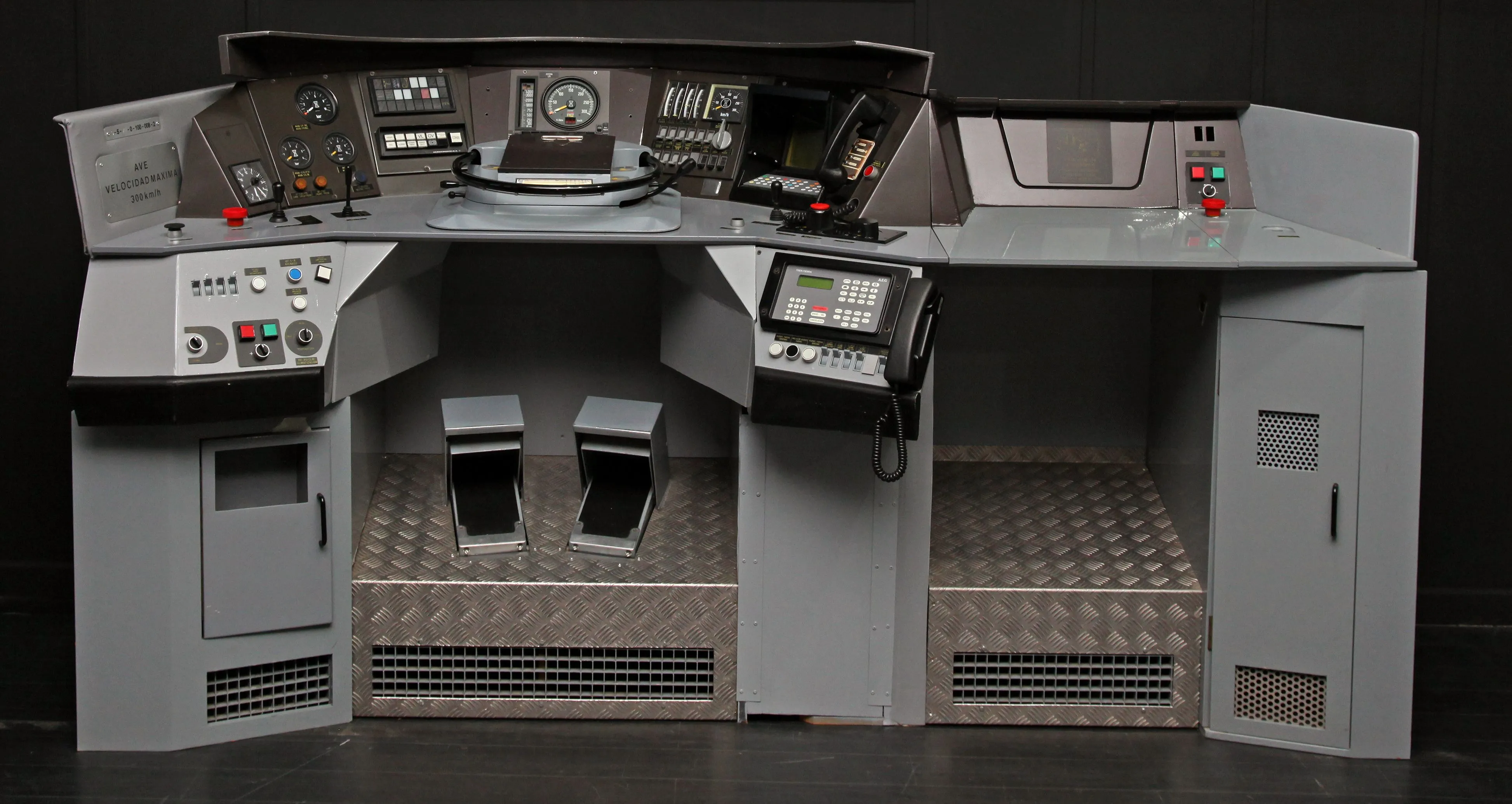 Train driver's cab replica with control panels and steering wheel