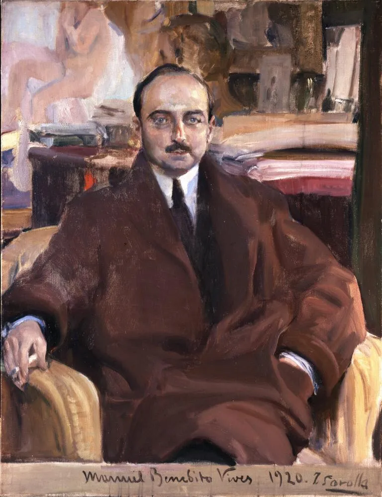 Portrait of a man in a brown coat sitting in a chair, with a painting in the background and text at the bottom reading 'Manuel Benedito Vives 1920. Z. Forolli'