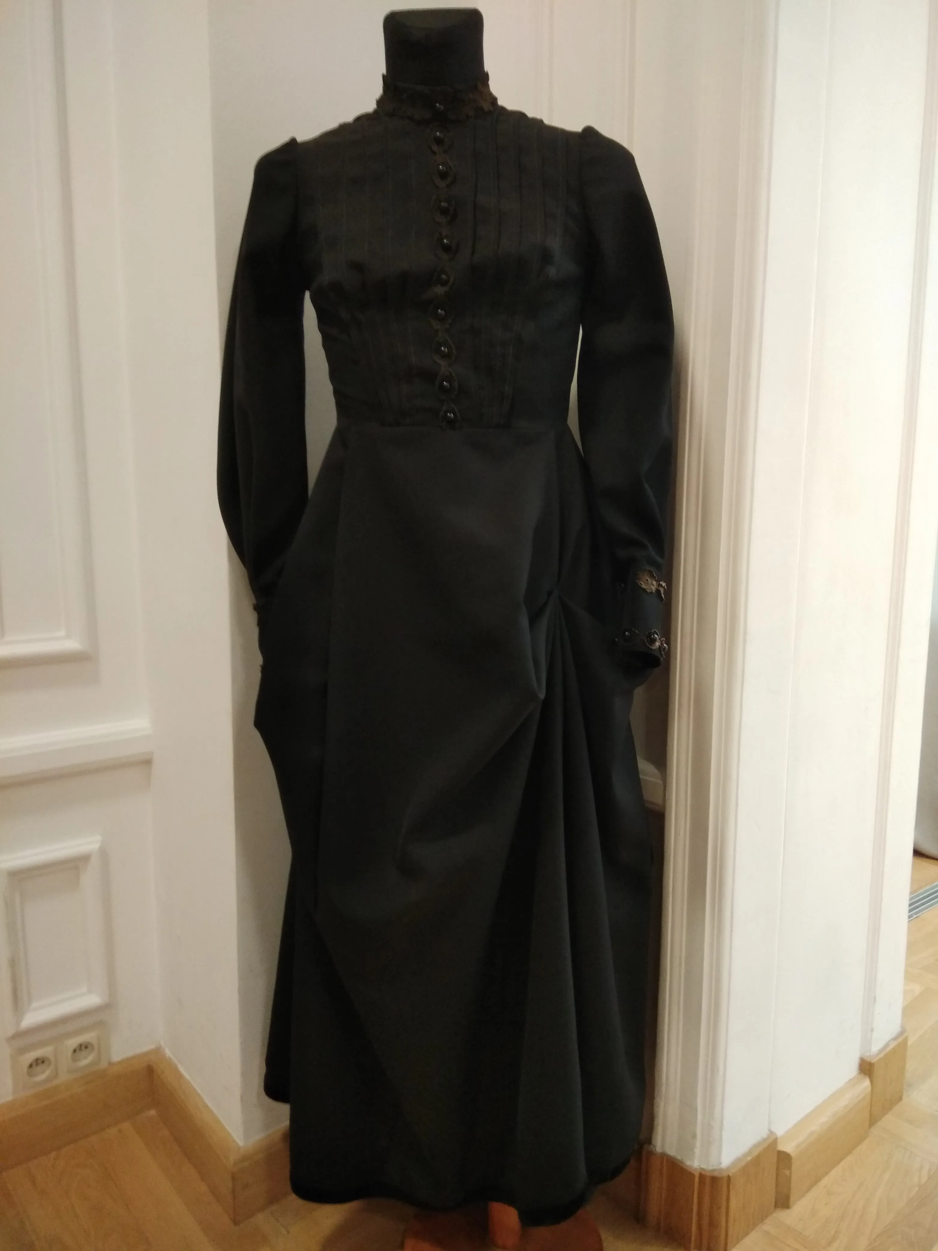 black historical dress on a mannequin in a museum display