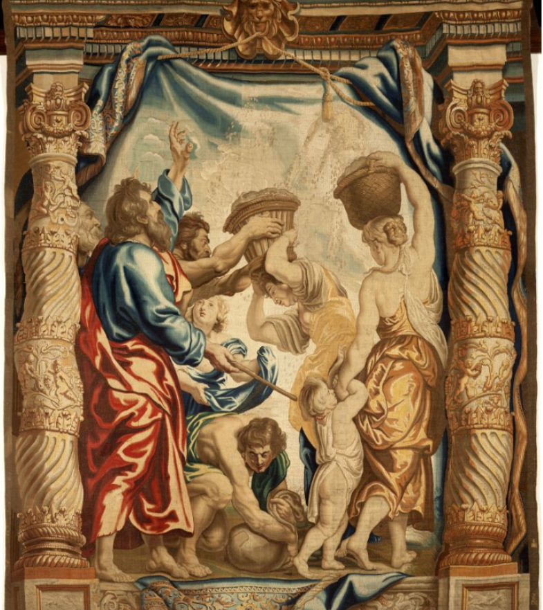 A tapestry with a religious scene featuring figures in classical attire, framed by ornate columns and a blue drapery