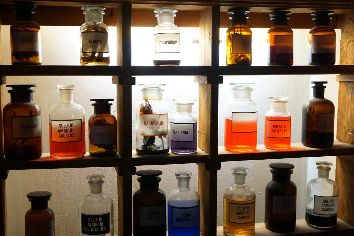 Wooden shelves holding numerous glass bottles with various colored liquids and handwritten labels