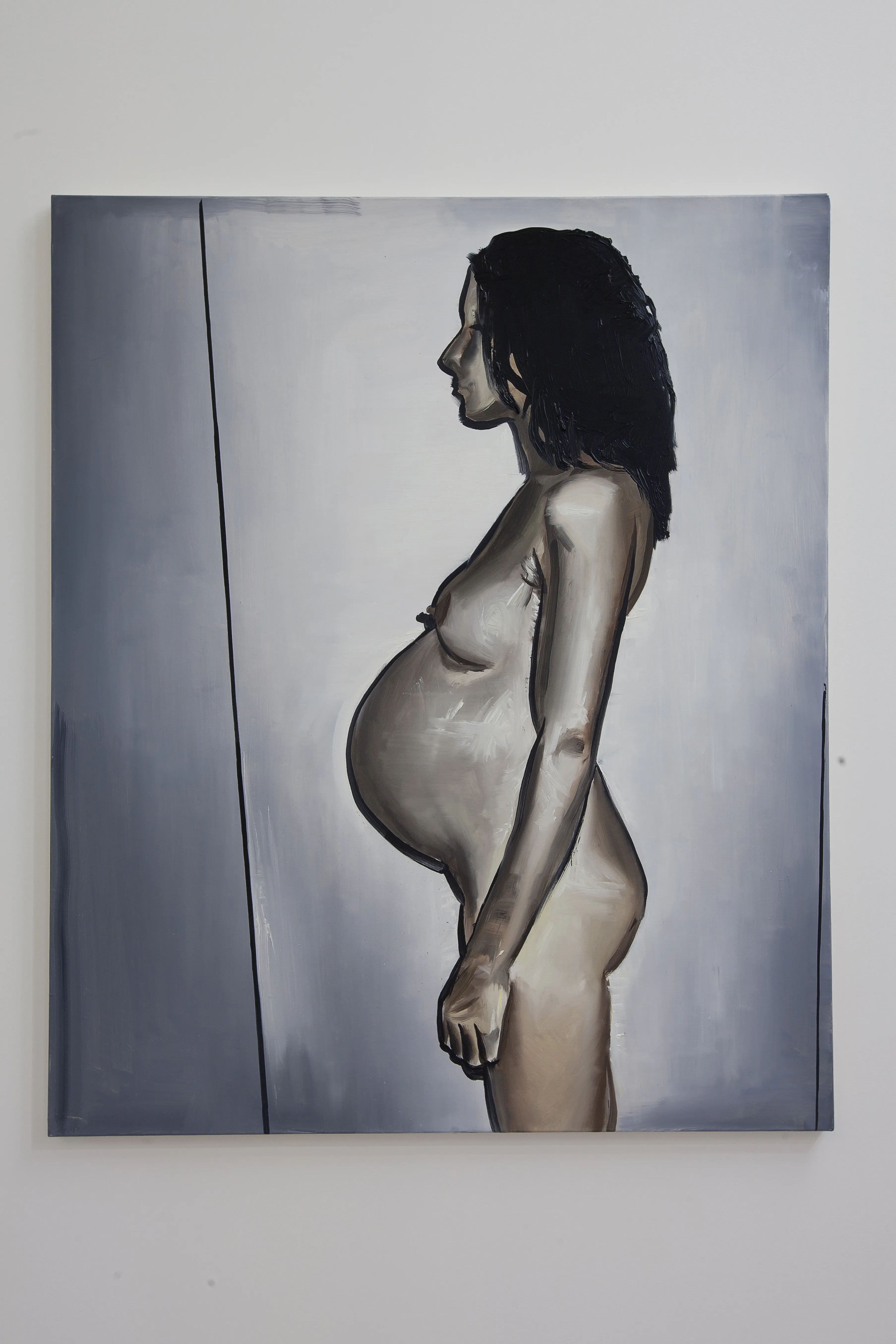 A painting of a pregnant woman in profile, displayed on a wall.