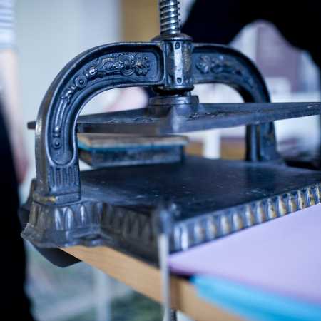 close-up of a vintage printing press with ornate metalwork