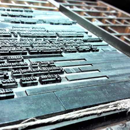 close-up of metal type blocks arranged in a printing press forme