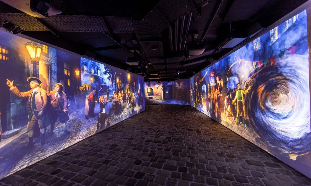 Immersive projection mapping on walls in a dimly lit corridor with cobblestone floor