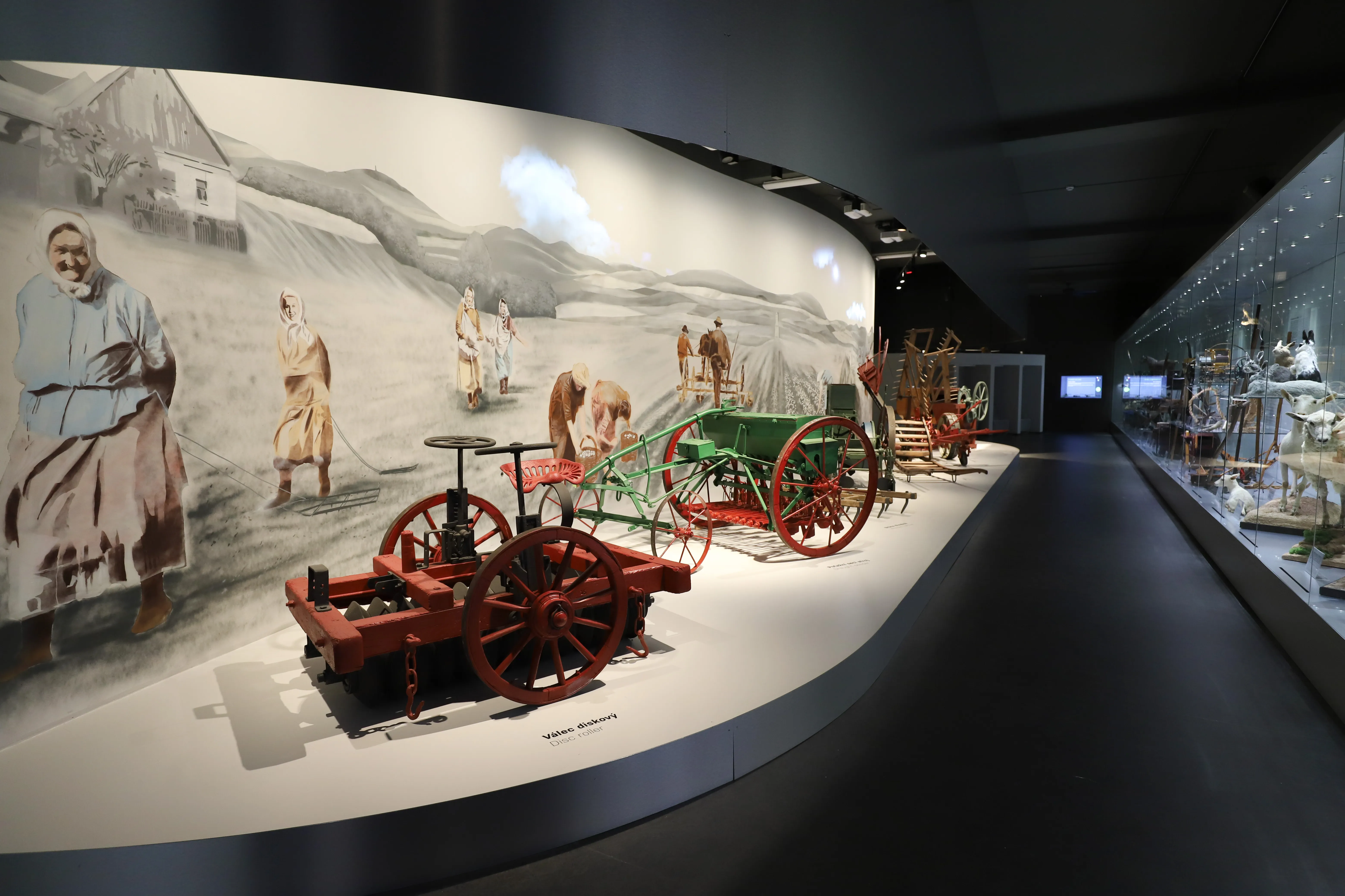 Exhibition of historical agricultural machinery and a mural in the National Museum of Agriculture