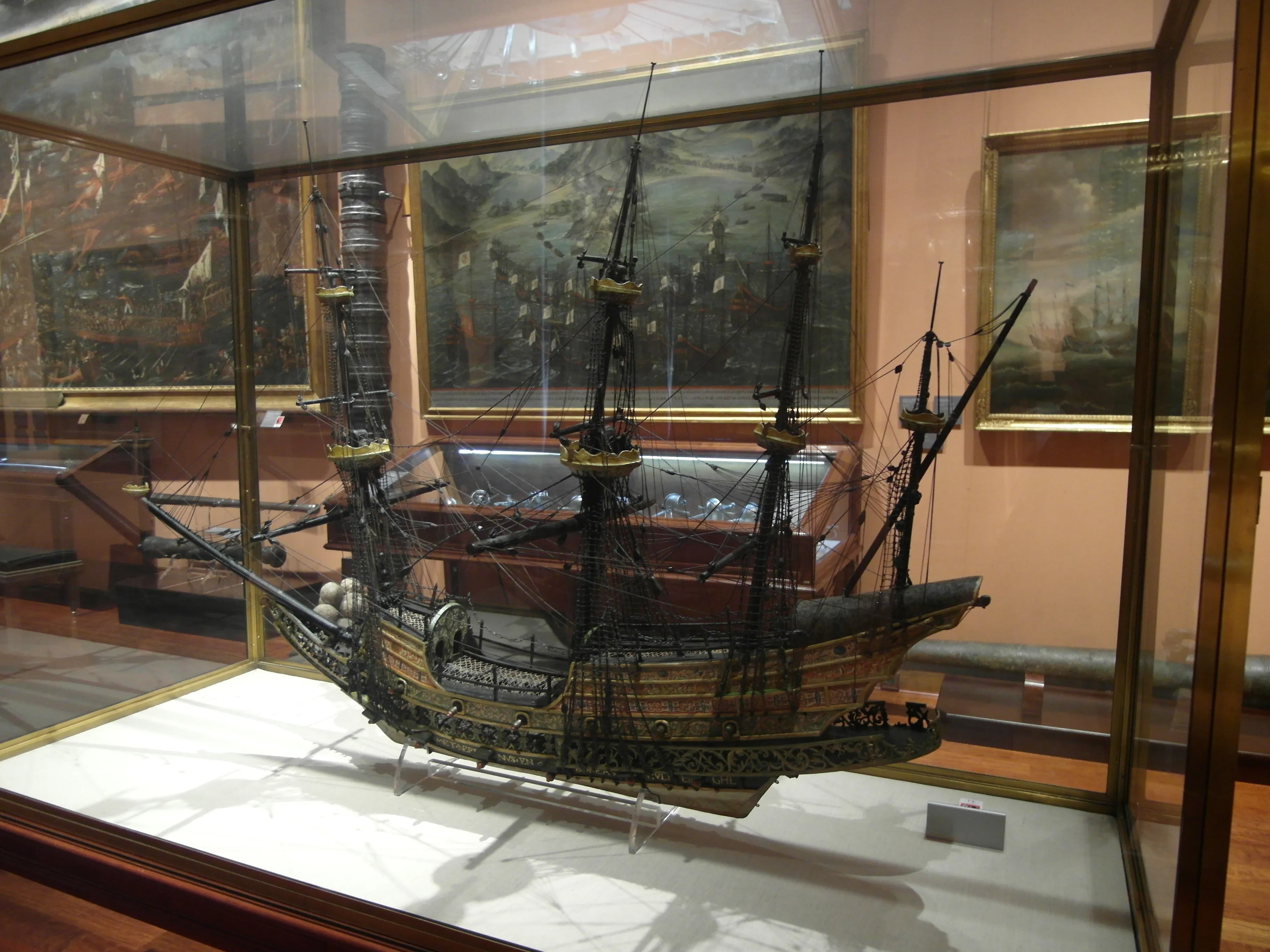 A large ship model in a glass display case inside a museum