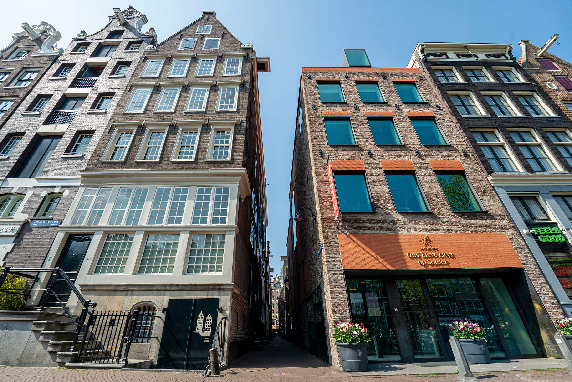 Exterior view of Ons' Lieve Heer op Solder museum, showing its canal house facade with adjacent historic buildings in Amsterdam.