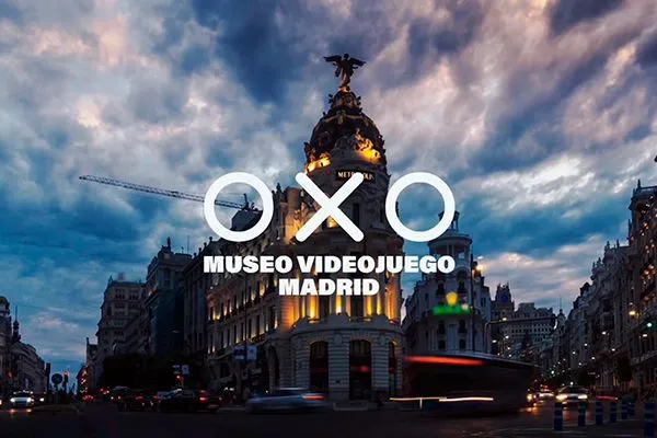 The OXO Video Game Museum Madrid sign overlaid on an exterior view of a grand building at dusk with a dramatic sky