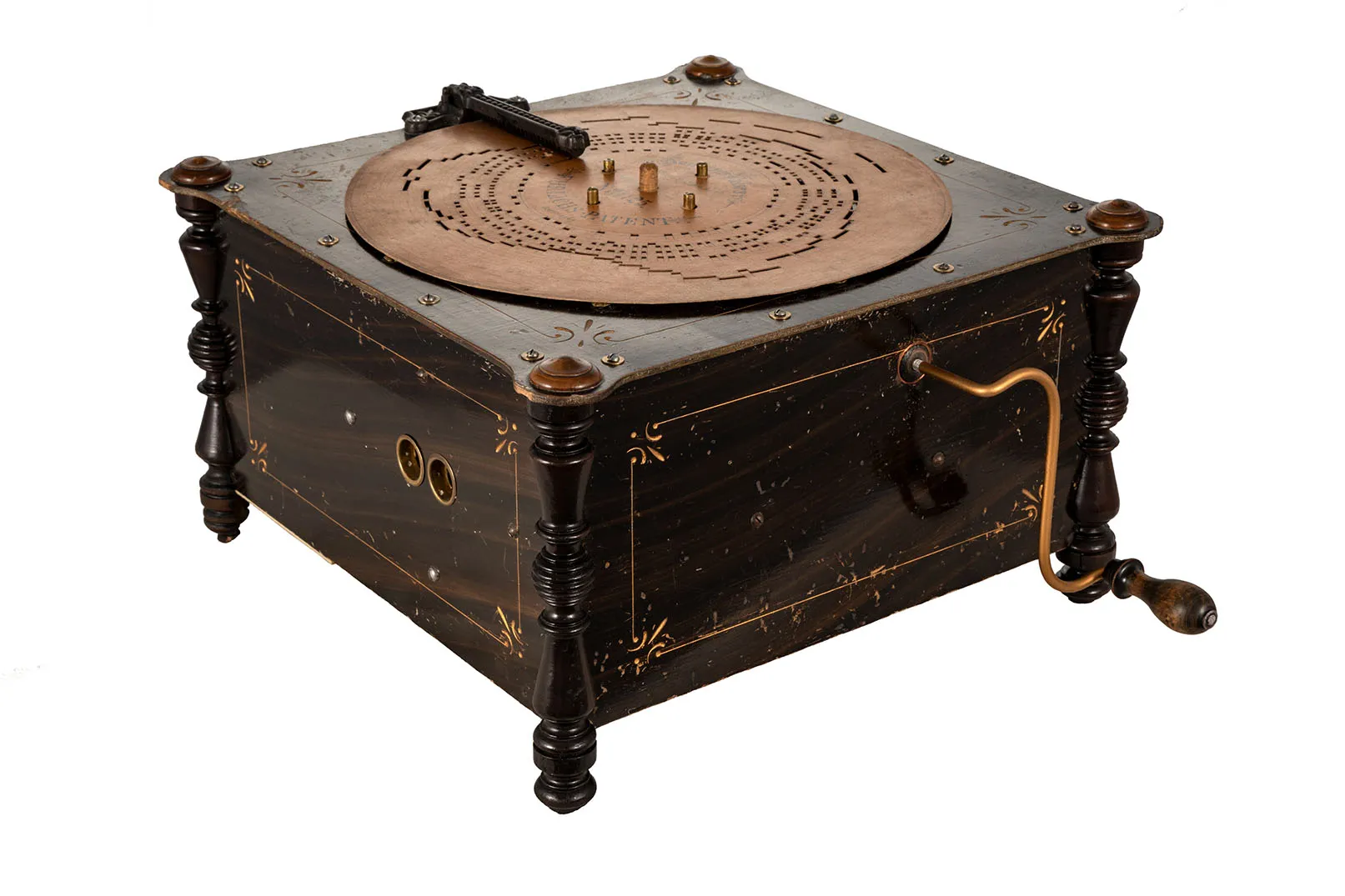 vintage wooden music box with brass crank and circular disc mechanism