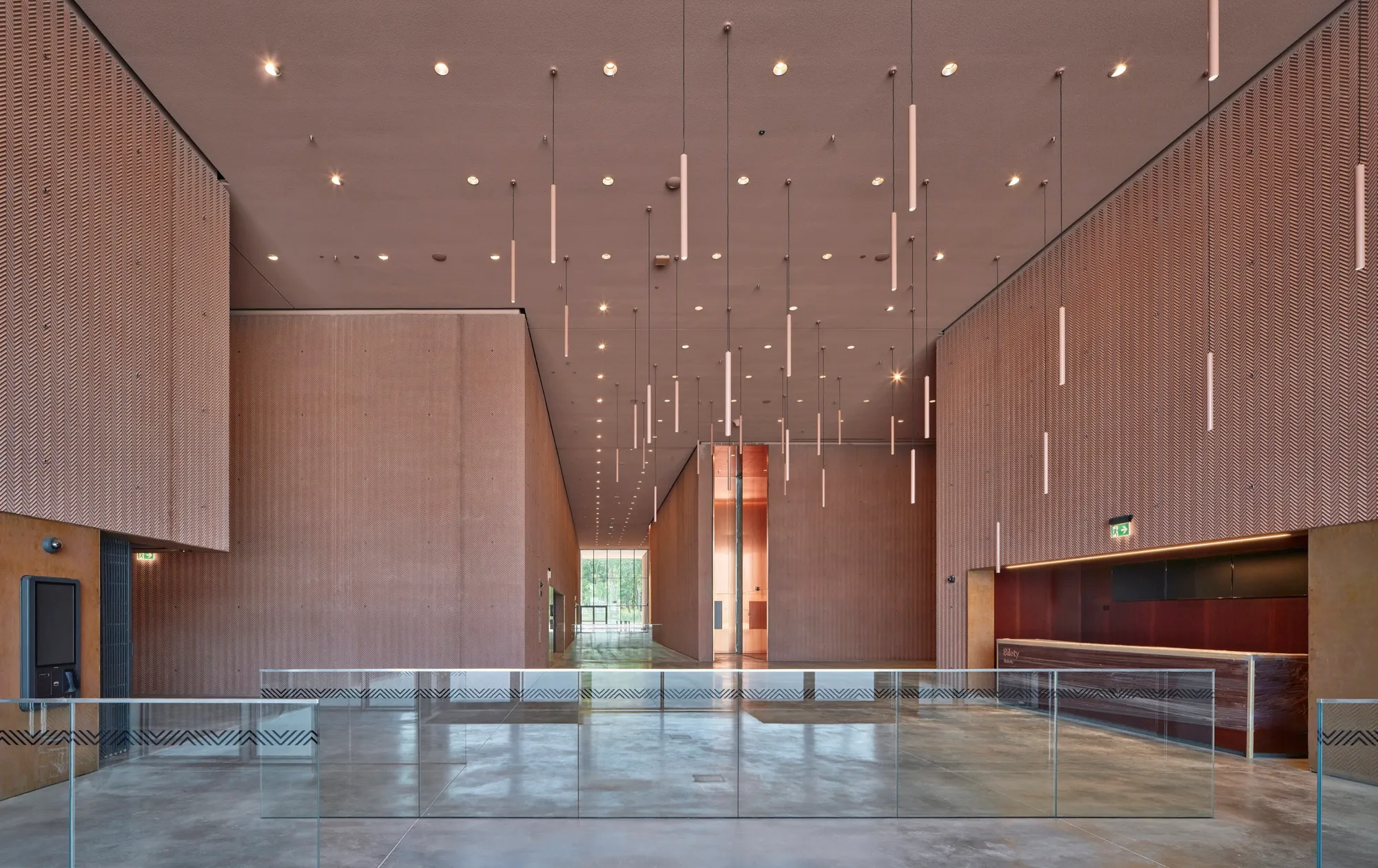 Moderne inkomhal met houten lambrisering, hanglampen en glazen balustrade