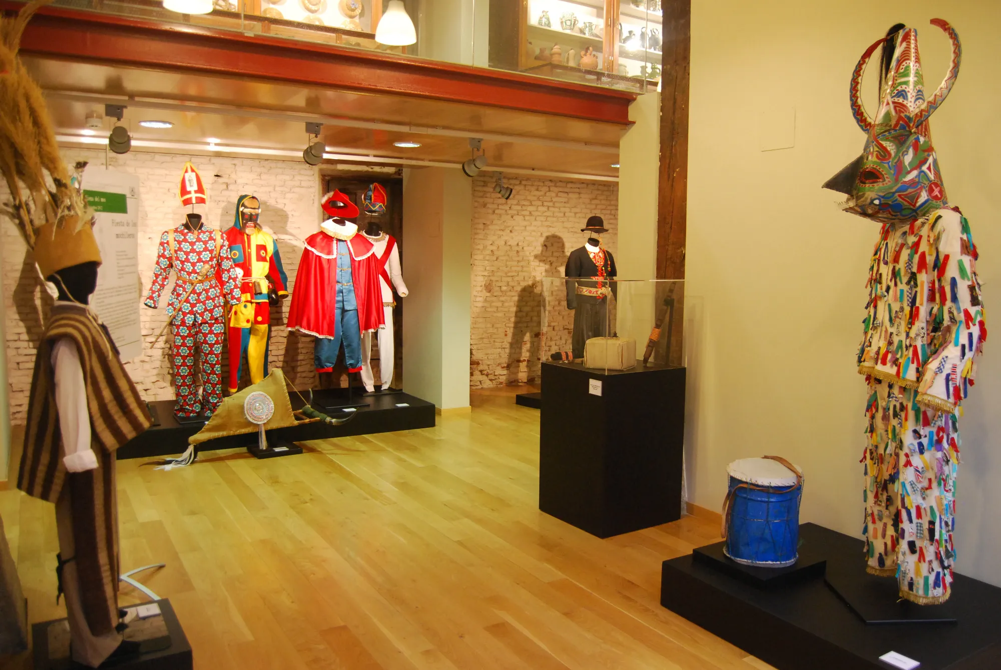 Interior gallery with colorful traditional costumes and folk art on display