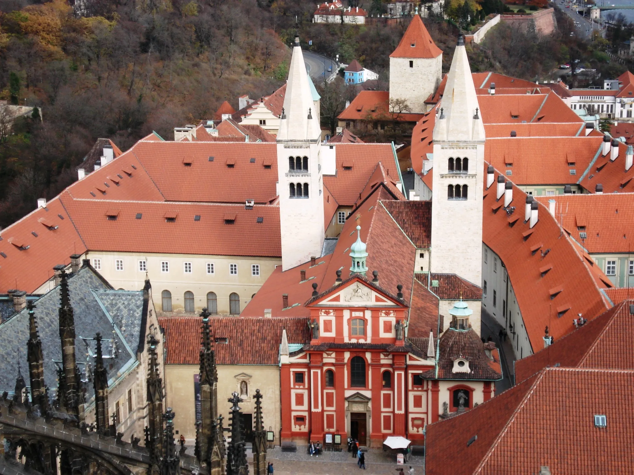 Aerial view of Prague Castle with red-roofed buildings and white spires