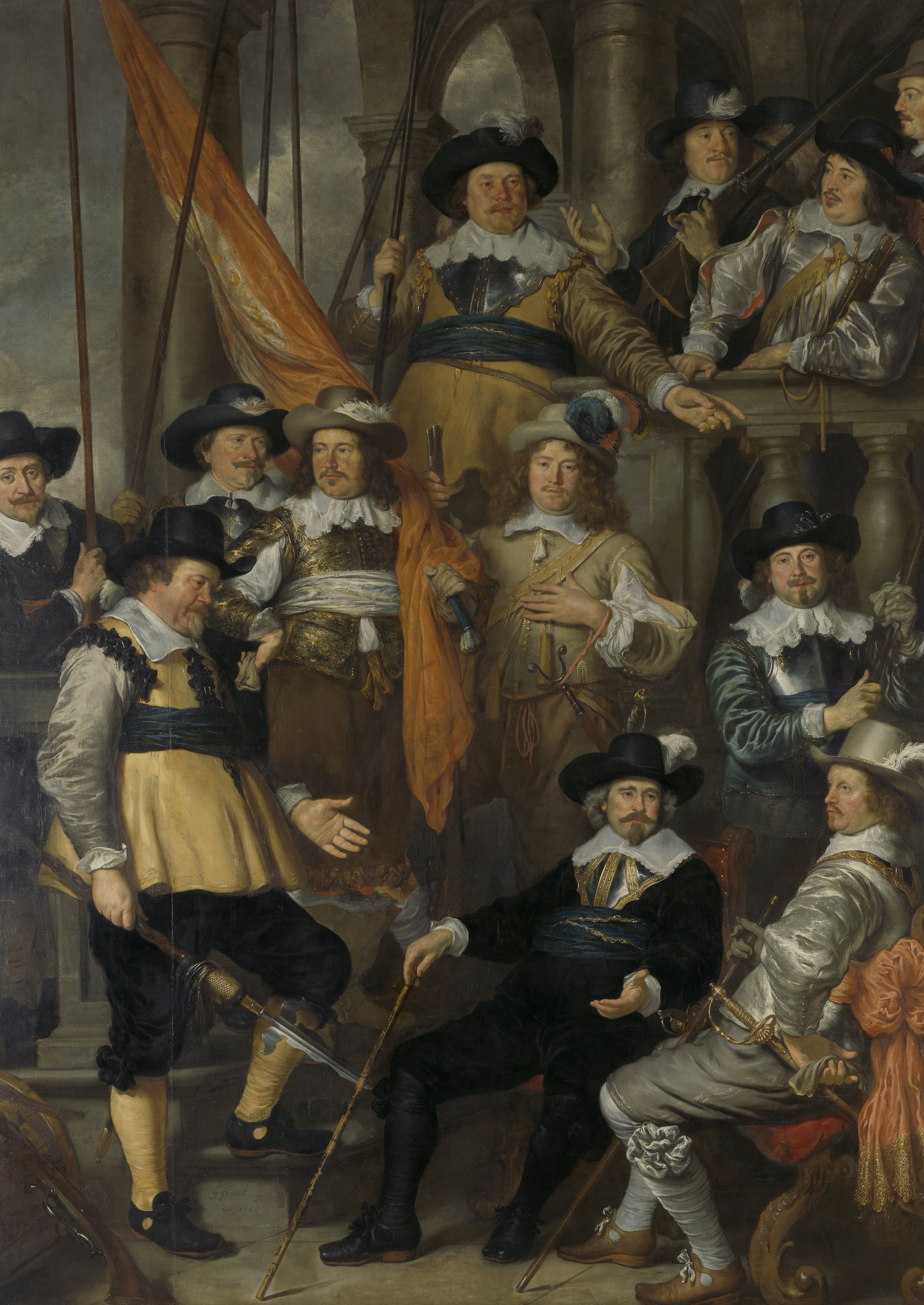Groepsportret van mannen in 17e-eeuwse Nederlandse kleding, waaronder hoeden, geplooide kragen en uniformen, met één man die een vlag vasthoudt en een ander die een staf vasthoudt.
