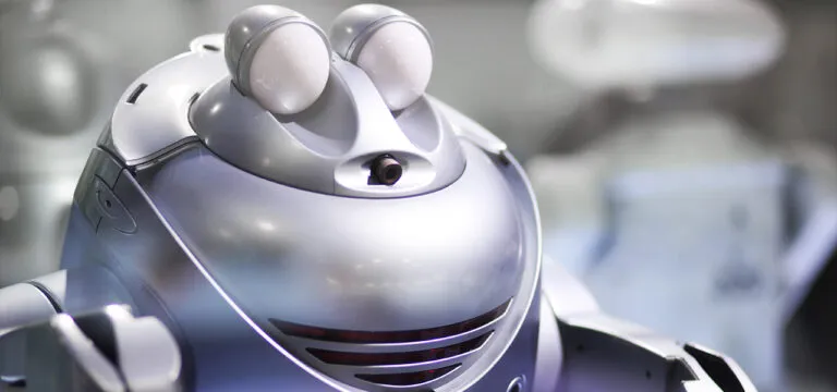 Close-up of a silver robot with large round eyes and a smooth metallic finish