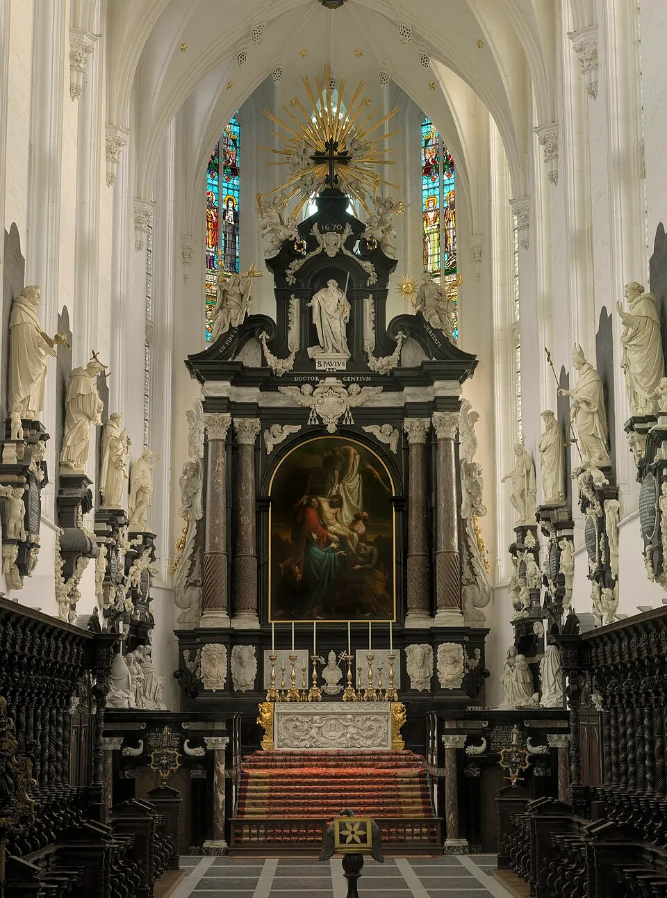 Interior de Saint Paul's Church, que presenta un ornamentado altar barroco con una pintura central y filas de estatuas blancas que bordean la nave.