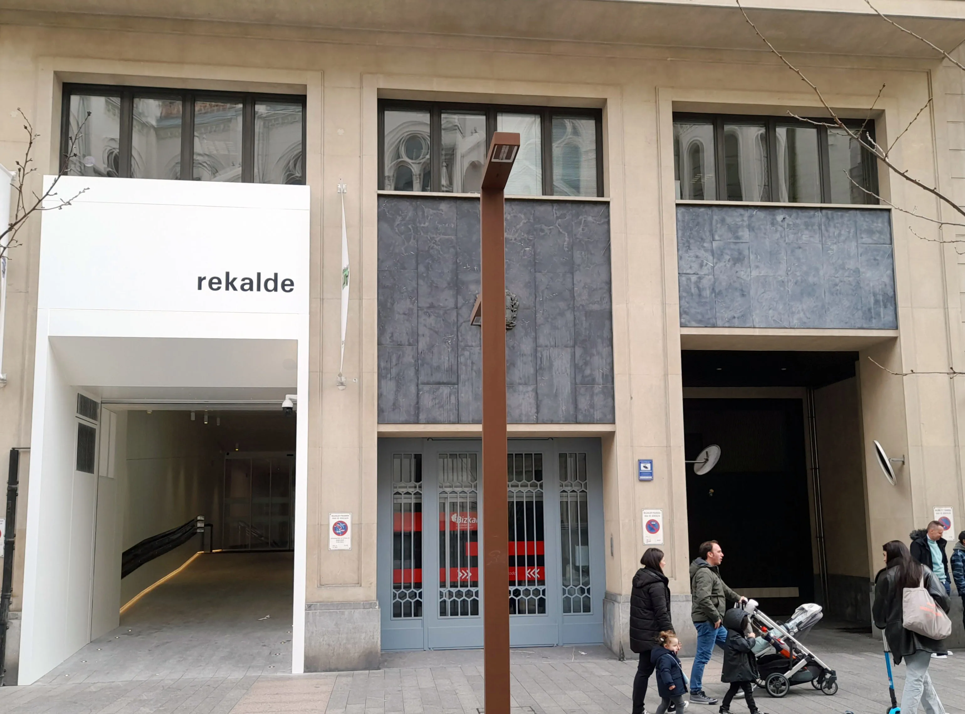 Exterior facade of Sala Rekalde showing the entrance with 'rekalde' signage on a white panel, with pedestrians walking in front