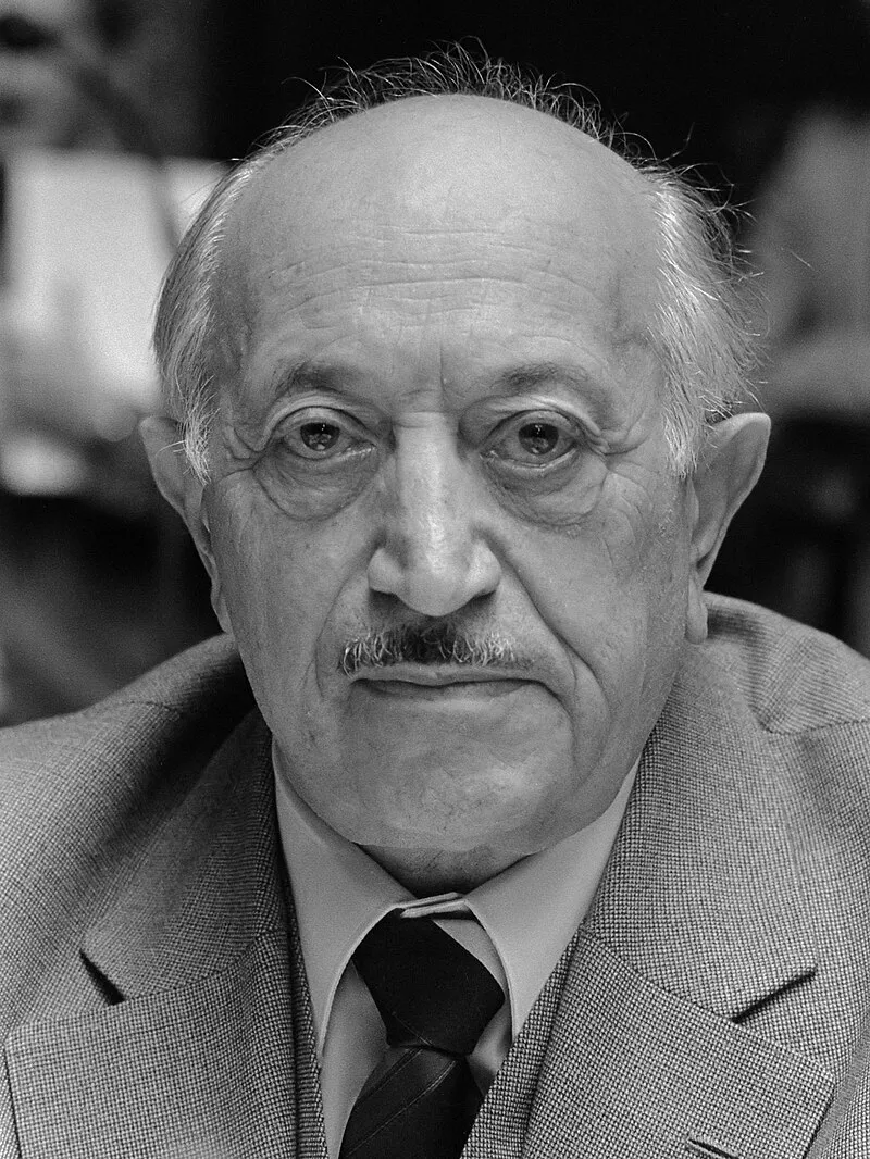 black and white portrait of an elderly man with a mustache wearing a suit and tie