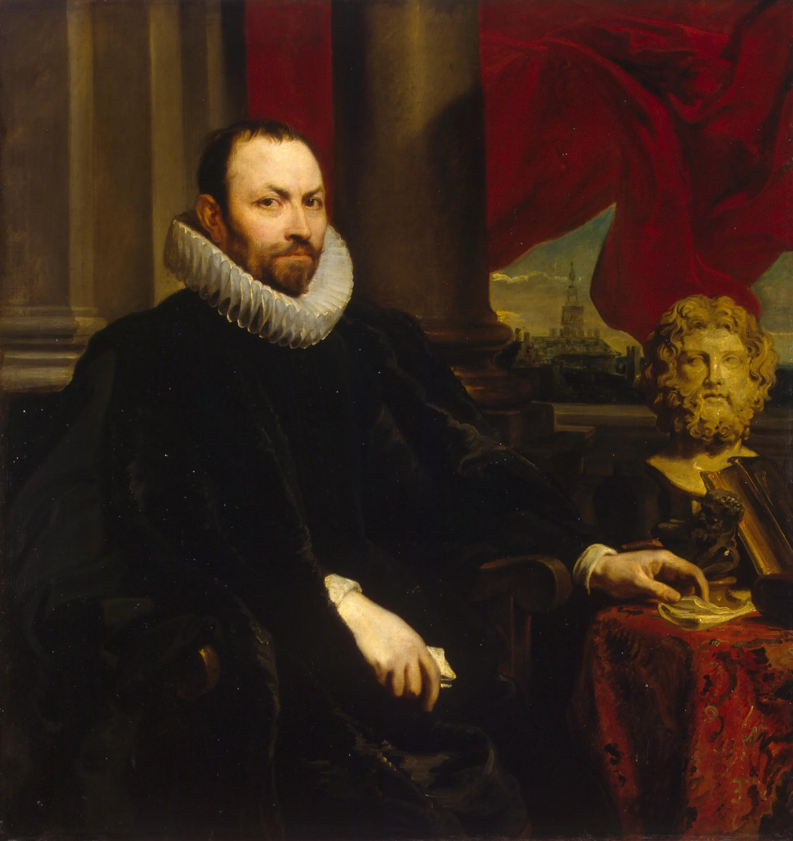 Pintura al óleo de un hombre sentado con barba y cuello de gorguera blanco, apoyando la mano cerca de un busto clásico sobre una mesa cubierta con un paño rojo.