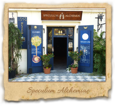 Blue doors with alchemical symbols and a sign reading Speculum Alchemiae above the entrance to a building