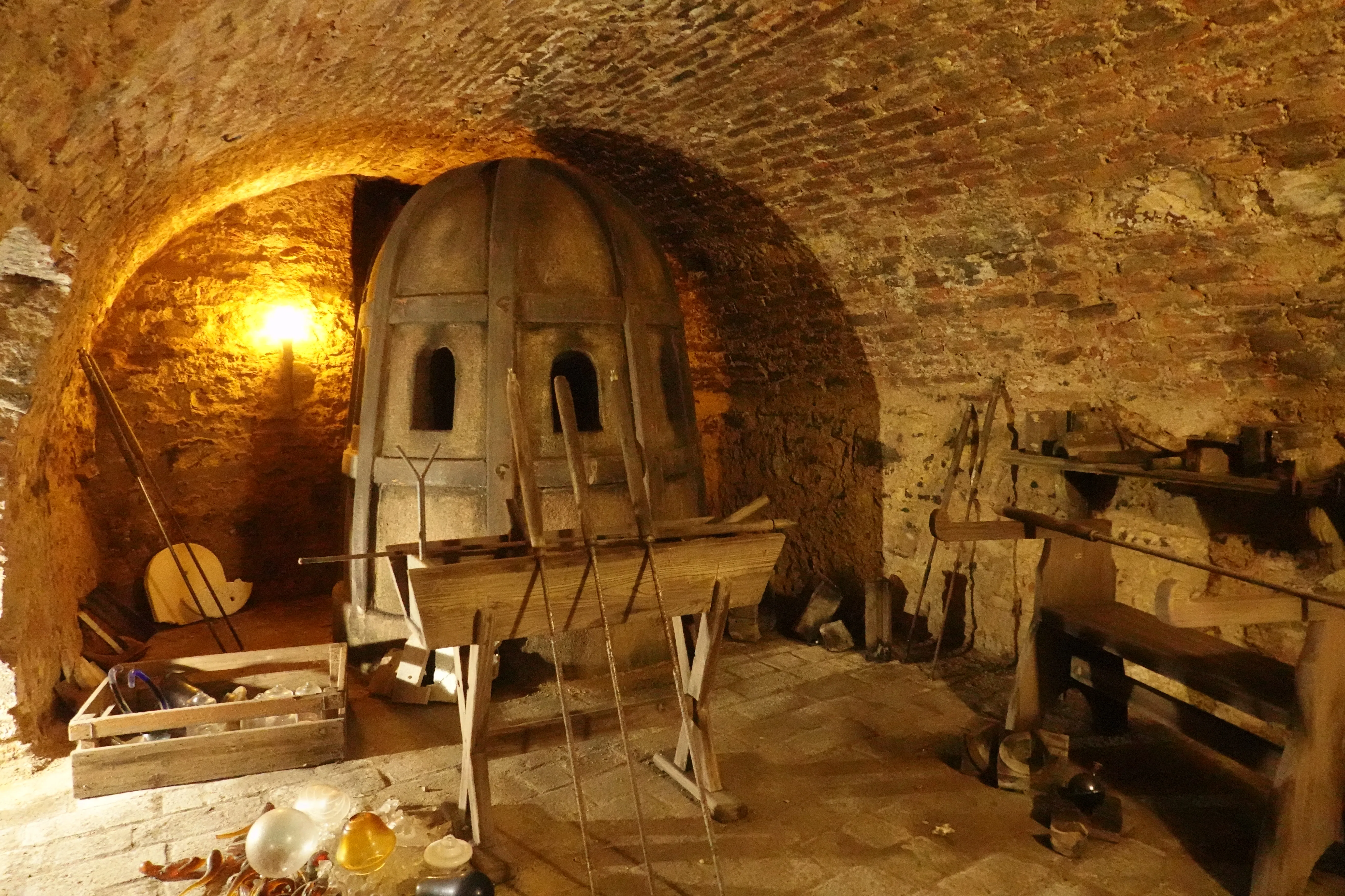 underground chamber with brick walls and a large dome-shaped furnace