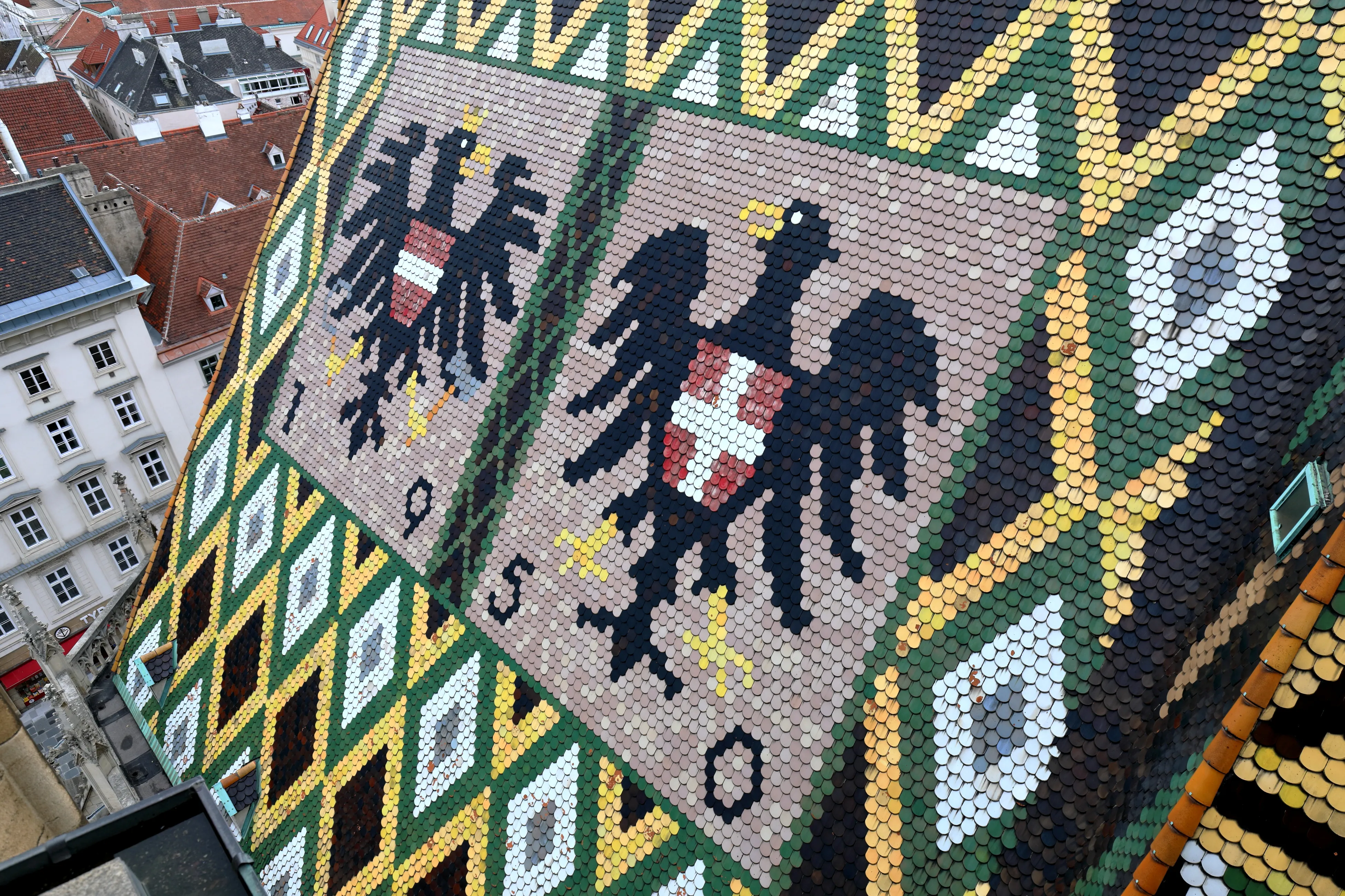 Mosaic roof detail of St. Stephen's Cathedral with black eagles and geometric patterns